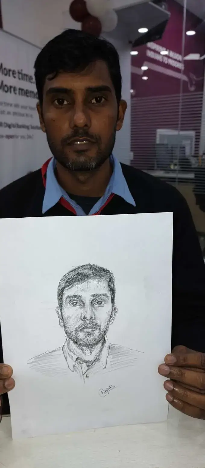 Customer holding portrait by Deepak - live sketch event Delhi
